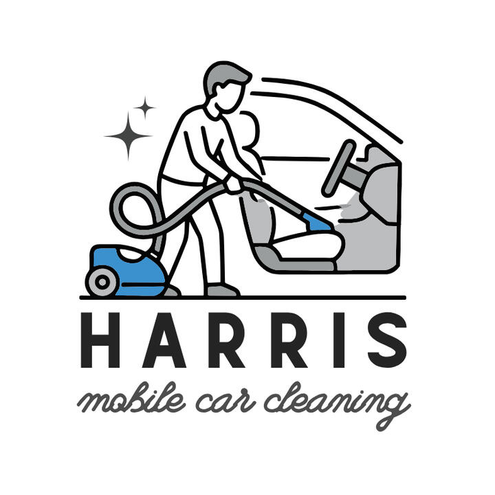 A man cleaning the interior of a car with a vacuum